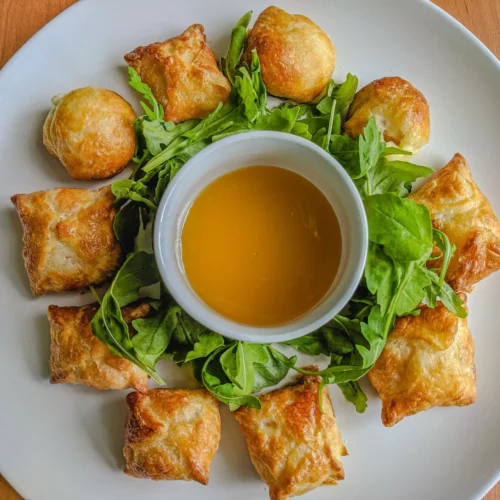 A plate of homemade shrimp puffs with some mango pineapple dipping sauce