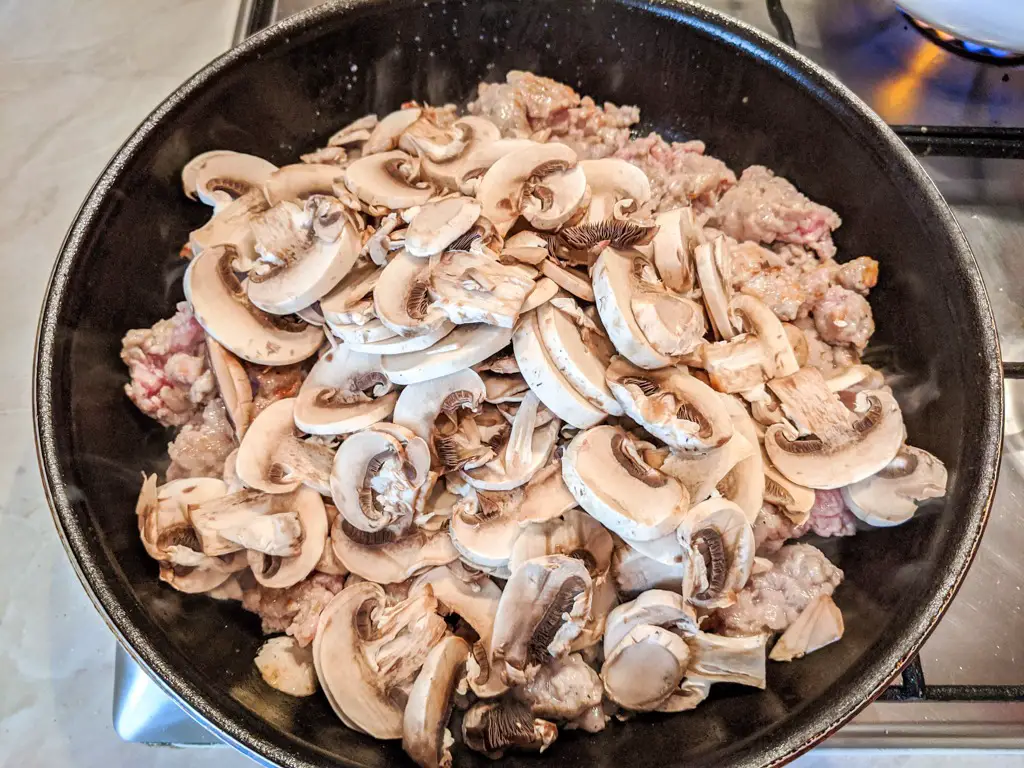 adding mushrooms to the meat