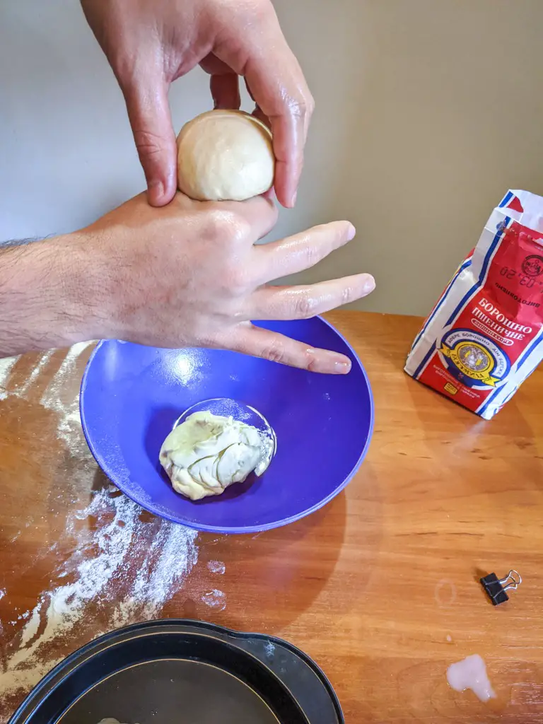 Pinching off a ball of dough for the pampushky 