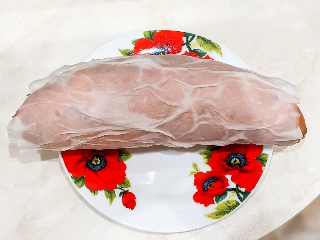 sweet potato wrapped in a damp paper towel on a plate