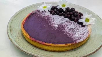 blackcurrant curd tart with powdered sugar and blackcurrant berries with flowers