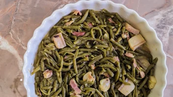 Southern Style Green Beans with bacon and fatback in a chafing dish on a marble counter