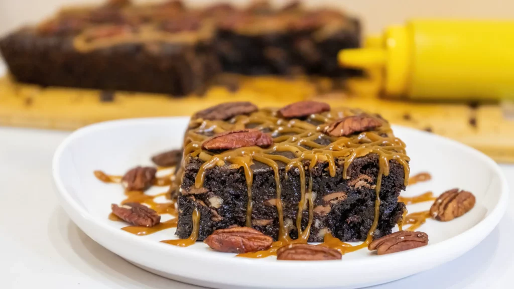 caramel pecan brownies with pecans and a homemade caramel drizzle