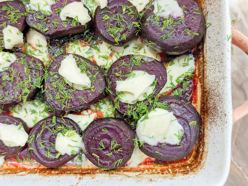 melting beets in a baking dish with cheese and dill
