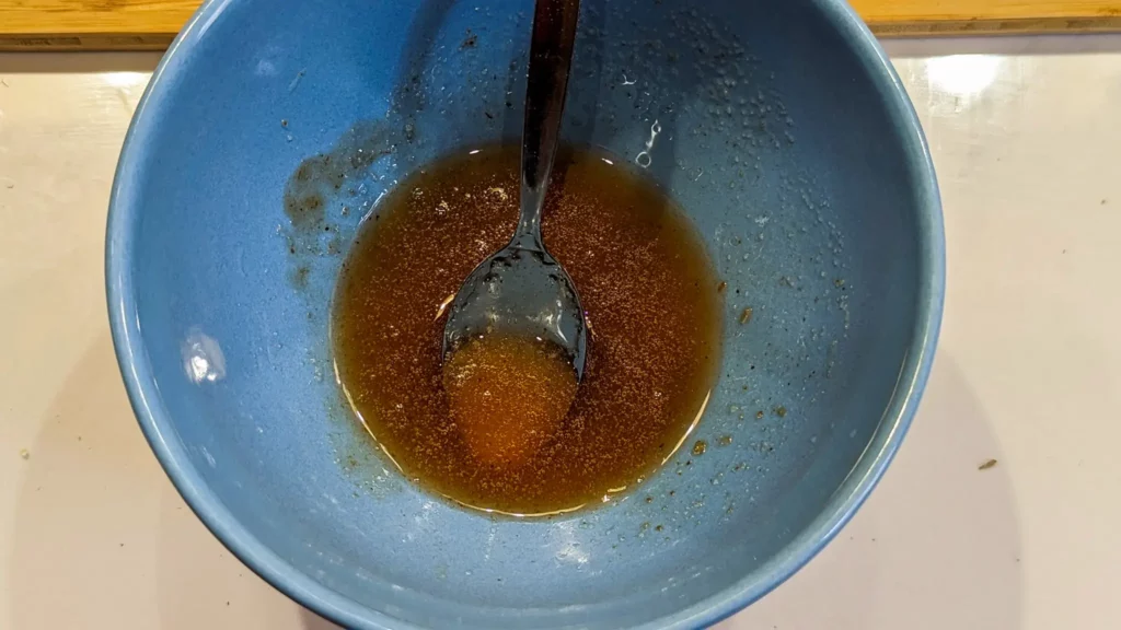 hot honey mix in a blue bowl with a spoon