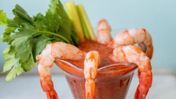 shrimp cocktail in a parfait glass with parsley and celery