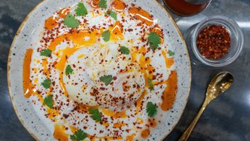 Turkish eggs aka cilbir on garlicky yogurt and plenty of chili oil