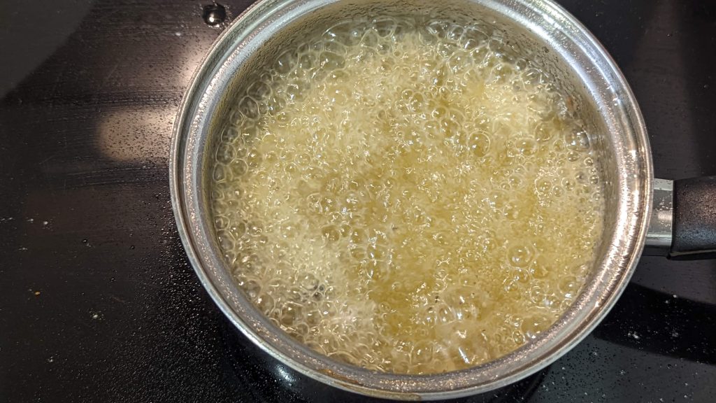 a pot of boiling oil on the stove