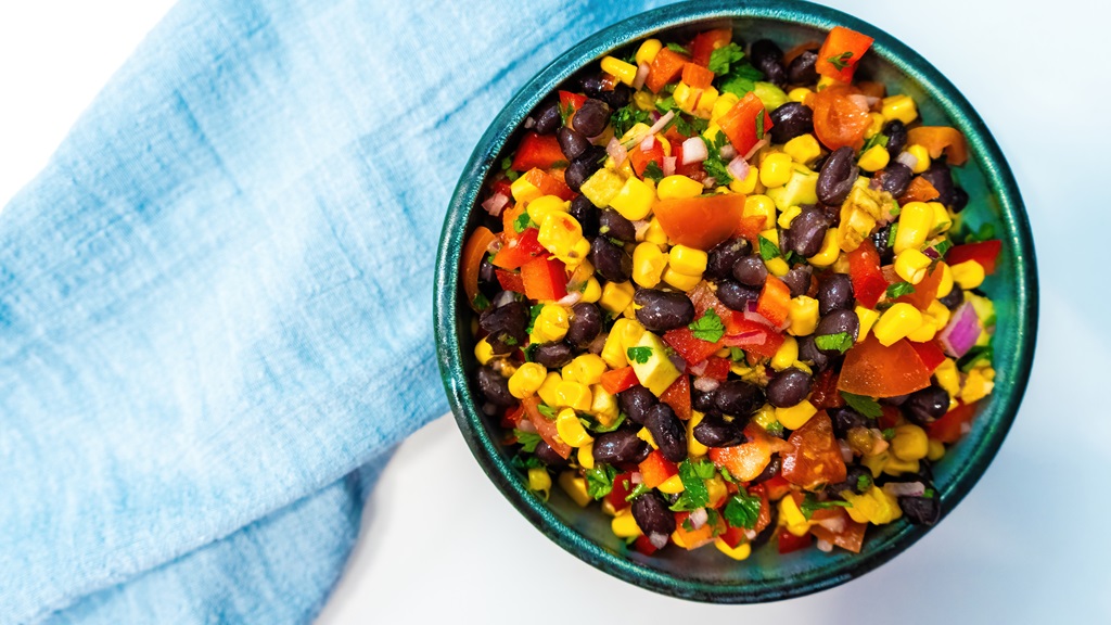 black bean salsa in a bowl with a blue kitchen towel