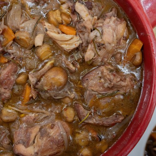 lapin au vin rouge in a red pot with sides